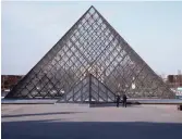  ?? — AP ?? File photo shows police officers patrol at the pyramid outside the Louvre museum in Paris.