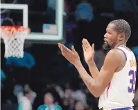  ?? CHRIS CARLSON/ASSOCIATED PRESS ?? Phoenix forward Kevin Durant celebrates after his new team’s win against the Charlotte Hornets on Wednesday. Durant, acquired in a trade from the Brooklyn Nets scored 23 points.