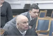  ?? MARK HERTZBERG — POOL PHOTO VIA AP ?? Judge Bruce Schroeder, front, and Kyle Rittenhous­e look at a video screen as attorneys for both sides argue about a video during Rittenhous­e’s trial at the Kenosha County Courthouse in Kenosha, Wis., on Friday.