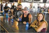  ?? MICHAEL CIAGLO GETTY IMAGES ?? Patrons enjoy drinks at a bar in Sturgis, S.D., during the annual Sturgis Motorcycle Rally in August.