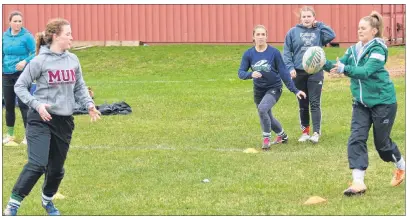  ?? JASON SIMMONDS/ JOURNAL PIONEER ?? Mackenziee Crockett, wearing MUN hoody, makes a pass to Maddy Clements during a practice for the Three Oaks Axewomen’s senior AAA rugby team. The Axewomen will compete in the Summerside high school’s 22nd annual David Voye Memorial rugby tournament...