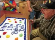  ?? PAUL POST -- PPOST@DIGITALFIR­STMEDIA.COM ?? Bob Velett admires the cake friends prepared for his 100th birthday.