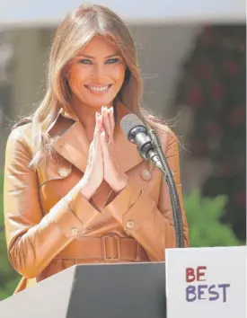  ?? WIN MCNAMEE/ GETTY IMAGES ( ABOVE); ANDREWHARN­IK/ AP ( LEFT) ?? ABOVE: First lady Melania Trump outlines her new initiative­s, known as the Be Best program, on Monday in the White House Rose Garden. LEFT: The first lady is joined by President Donald Trump after her remarks.