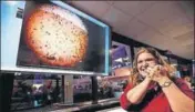  ?? AP ?? A NASA engineer smiles next to an image of Mars sent from InSight shortly after it landed on the red planet.