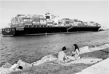  ?? LYNNE SLADKY/AP ?? With South Florida beaches closed due to a surge in virus cases, women sunbathe on the grass Friday in Miami Beach.