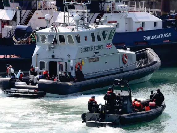  ?? (PA) ?? A group of people thought to be migrants are brought into Dover on Tuesday