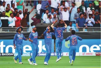  ?? Virendra Saklani/Gulf News ?? India players celebrate the wicket of Pakistan captain Sarfaraz Ahmad on Wednesday. India put on a dominant show to defeat their arch-rivals by eight wickets.