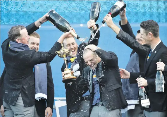  ?? ASSOCIATED PRESS ?? European captain Paul McGinley is doused with champagne during the team’s celebratio­n.
SCOTT HEPPEL