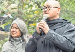  ??  ?? Umbrella Movement protester Shiu Ka-chun (right) addressing a rally beside pro-democracy lawmaker, Leung Kwok-hung, also known as ‘Long Hair’ at Central Plaza, opposite the venue of the Hong Kong Chief Executive election. — AFP photo