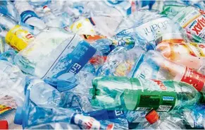  ?? — AFP Relaxnews ?? Stack of crushed, colourful plastic bottles waiting to be recycled.