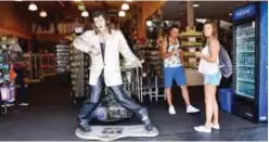  ??  ?? A statue of Elvis Presley fronts a tourist gift shop at the corner of Hollywood Boulevard and Highland Avenue on August 14, 2017 in Hollywood. — AFP photos