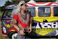  ?? SETH WENIG - THE ASSOCIATED PRESS ?? In this Thursday, Aug. 15 photo, a man who calls himself “Run-A-Way Bill” stands in front of a Volkswagen bus while waiting for the gates to open at a Woodstock 50th anniversar­y event in Bethel, N.Y.