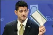  ?? THE ASSOCIATED PRESS ?? House Speaker Paul Ryan of Wis., holds up a copy of a proposed “simple tax” postcard while speaking at the Heritage Foundation in Washington Thursday.