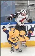  ?? The Canadian Press via AP - Jason Franson ?? The Coyotes’ Jakob Chychrun (6) checks the Predators’ Craig Smith during the first period of Tuesday’s game.