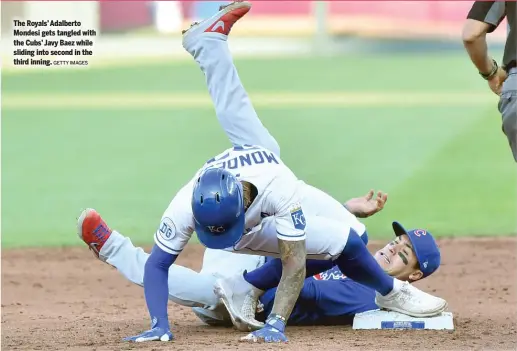  ?? GETTY IMAGES ?? The Royals’ Adalberto Mondesi gets tangled with the Cubs’ Javy Baez while sliding into second in the third inning.