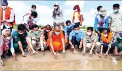  ?? WCS CAMBODIA ?? WCS and fishery officials release 100 baby turtles into the Mekong River in Sambo district of Kratie province on May 23.