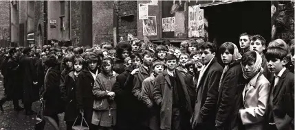  ??  ?? That was then: Children line up outside the Cavern club back in the Beatles’ 1960s heyday