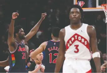  ?? NATHAN DENETTE/THE CANADIAN PRESS ?? Raptors forward OG Anunoby walks away as 76ers centre Joel Embiid celebrates his game-winning shot with teammate Tobias Harris at the conclusion of Wednesday's night's playoff contest in Toronto. The Raptors trail the Sixers 3-0 in the opening-round set.