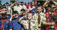  ?? ASSOCIATED PRESS ?? Boy Scouts and Cub Scouts salute during a Memorial Day ceremony in Linden, Mich. The Boy Scouts of America will let girls join Cub Scouts next year and create a program for older girls in 2019.