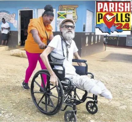  ?? (Photo: Garfield Robinson) ?? Seventy-one-year-old Llewellyn Suarez is assisted by Marene Manning after voting in the Mocho Division in Clarendon on Monday.