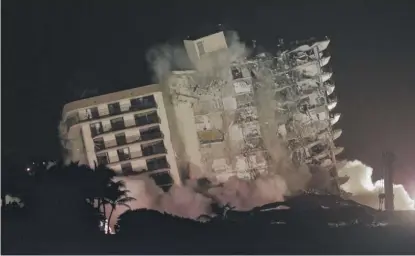  ?? LYNNE SLADKY/AP ?? The damaged remaining structure at the Champlain Towers South condo building in Surfside, Florida, collapses in a controlled demolition late Sunday.