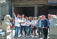  ??  ?? Above left: Volunteers from Henan province guide visitors to an old temple in Taiyuan, Shanxi province.