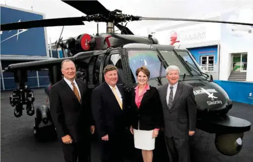  ??  ?? SIKORSKY BLACK HAWK HELICOPTER UNVEILED: LOCKHEED MARTIN CHAIRMAN, PRESIDENT AND CEO MARILLYN HEWSON (THIRD FROM LEFT) WITH (FROM LEFT) SIKORSKY PRESIDENT DAN SCHULTZ; EXECUTIVE VICE PRESIDENT OF LOCKHEED MARTIN MISSILES AND FIRE CONTROL RICK EDWARDS;...