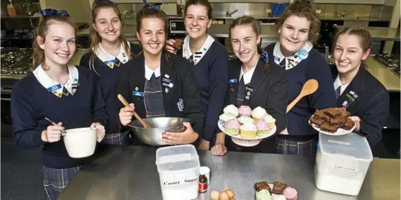  ?? PHOTO: NEV MADSEN ?? HEARTFELT BAKING: Fairholme College students get baking for Dalby students (from left) Phoebe Duncan, Lucy Cumming, Mia Doering, Madeleine Stiller, Hannah Cook, Arabella Gourlay and Lindy Roos.