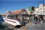  ?? ?? In this file photo tourists disembark after a boat ride in the old town of Chania on Crete Island as the tourist season has started on the island.