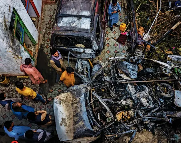  ??  ?? BLURRED VISION
Drone operators, looking through video feeds that may have been delayed, fired a missile at what was thought to be an attack in progress, killing civilians. Clockwise from top: wreckage from the August 29 U.S. drone attack in Kabul, Afghanista­n; General Kenneth F. Mckenzie Jr.; mourners for a victim of the attack.