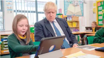  ?? — AFP ?? Britain’s Prime Minister Boris Johnson speaks to pupils as he visits Middleton Primary School in Milton Keynes, southern England.