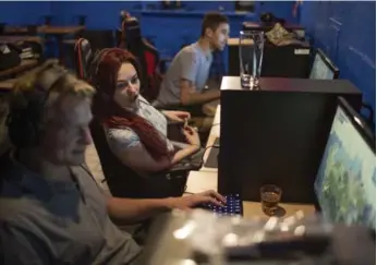  ?? MARCUS OLENIUK/TORONTO STAR ?? Gaming is popular among 20 and 30 year olds. Patron Emily Davidson settles in at Good Game Bar.