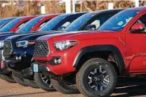  ?? David Zalubowski / Associated Press ?? 2021 Toyota pickups await sale on a lot in Englewood, Colo. The Tacoma was one of Toyota’s top selling vehicles in 2020.