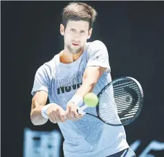  ?? — AFP photo ?? Serbia’s Novak Djokovic hits a return during a practice session ahead of the Australian Open tennis tournament in Melbourne.