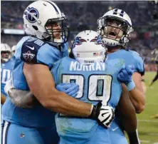  ?? AP PHOTO ?? HUG IT OUT: Running back DeMarco Murray (29) celebrates his touchdown during the Titans’ win.