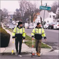  ?? Matthew Brown / Hearst Connecticu­t Media ?? Luke Buttenwies­er assists Traffic Engineer Garrett Bolella with surveying and marking new crosswalk and traffic patterns at Shippan and Wardell Avenues in Stamford.