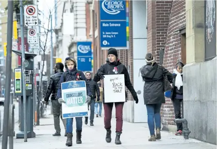  ?? NATHAN DENETTE/ THE CANADIAN PRESS ?? Teachers and faculty staff of the Ontario Public Service Employees Union walk the picket line at George Brown College in Toronto on Thursday.