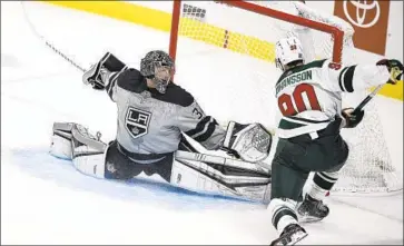  ?? Kelvin Kuo Associated Press ?? KINGS GOALIE Jonathan Quick, left, stretches to block a shot by the Wild’s Marcus Johansson.