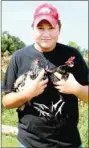  ??  ?? Dawson Swaffar, a member of Farmington FFA, will show hogs, broilers, hens and show birds at the Washington County Fair. He cares for his animals at his home.