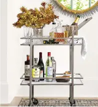  ?? Crate & Barrel ?? ■ A bar cart can lend a hand in entertaini­ng in a small space.