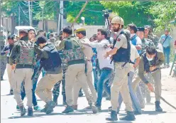  ?? ANI ?? Security personnel stop Kashmiri Pandits from marching towards the governor’s house to protest against the killing of Rahul Bhat, at Sheikhpora in Budgam on Friday.