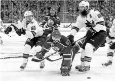  ?? JASON FRANSON/THE CANADIAN PRESS VIA AP ?? The Sharks’ Chris Tierney, left, and Brent Burns, right, trip up the Oilers’ Benoit Pouliot.