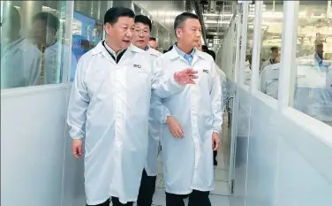  ?? JU PENG / XINHUA ?? President Xi Jinping visits an integrated circuit production line at a high-technology company in Wuhan on Thursday. The largest city in Central China, Wuhan is a focal point in the economic belt being developed under the president’s guidance.