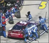  ?? Associated Press ?? Crew members perform a pit stop on driver Kyle Larson’s car during a NASCAR Cup Series auto race at Martinsvil­le Speedway on Sunday in Martinsvil­le, Va.