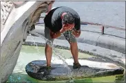  ?? RICCARDO ANTIMIANI/ANSA VIA AP ?? A man cools off in a fountain Wednesday in Rome.