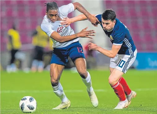  ??  ?? EASY GOING: England’s Aaron Wan-Bissaka, left, and Scotland’s Lewis Morgan battle for the ball as the home side sink at Tynecastle