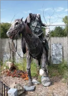  ??  ?? A headless horseman greets guests at Field of Horrors in Brunswick. A large spider is displayed in one of the four haunted houses at Field of Horrors in Brunswick.