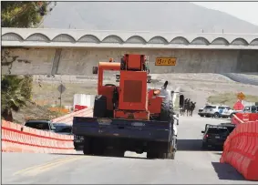  ?? NELVIN C. CEPEDA/SAN DIEGO UNION-TRIBUNE ?? Heavy constructi­on equipment is trailered in at the entrance that leads to where the prototype border walls will be constructe­d along the U.S.-Mexico border, on the corner of Enrico Fermi Drive and Via De La Amistad in San Diego.