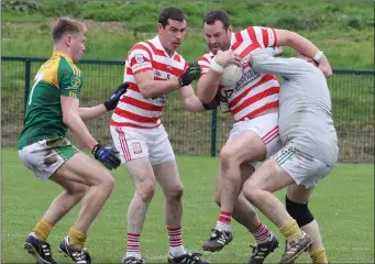  ??  ?? ColmWhelan of Ferns St. Aidan’s is tackled by HWH-Bunclody netminder Patrick Kavanagh with Peadair Cowman and John Breen awaiting developmen­ts in Saturday’s county semi-final.