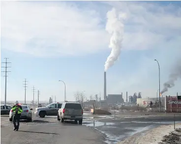  ?? OLIVIA CONDON / FORT MCMURRAY TODAY / POSTMEDIA NEWS FILES ?? First responders at the Syncrude base plant following and explosion and fire March 14.